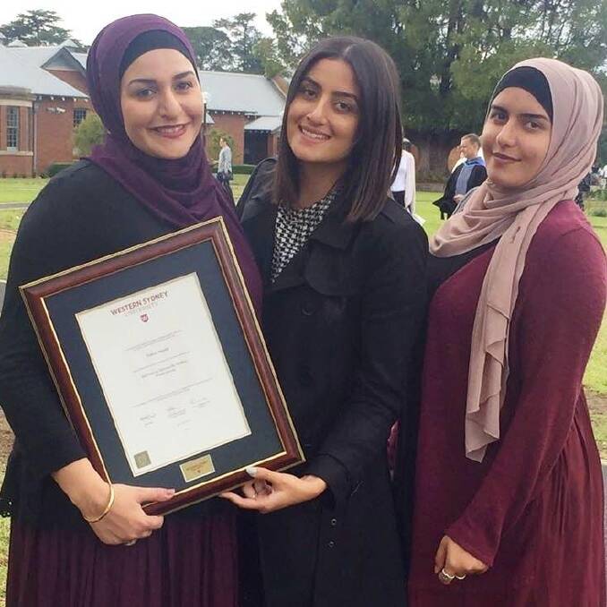 Amani, Nour and Ola with their mother's posthumous degree from Western Sydney University.