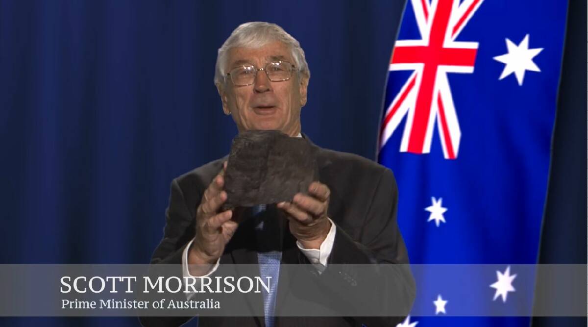 A screen grab of Dick Smith talking about renewable energy, holding a piece of coal and pretending to be Prime Minister Scott Morrison. Photo: dicksmithfairgo.com.au