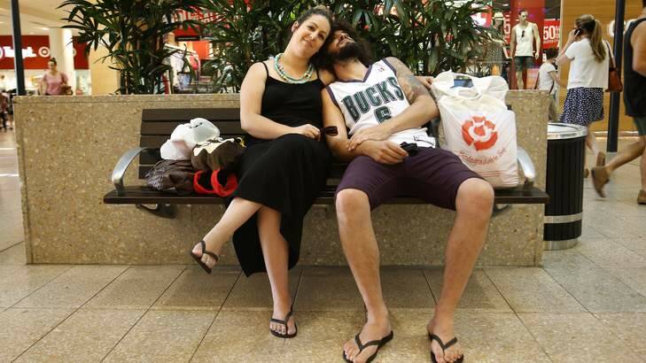 Melissa Peric from Weston Creek with partner Danny Clapp from Lyneham take a break from their Christmas shopping at the Canberra Centre. Photo: Jeffrey Chan
