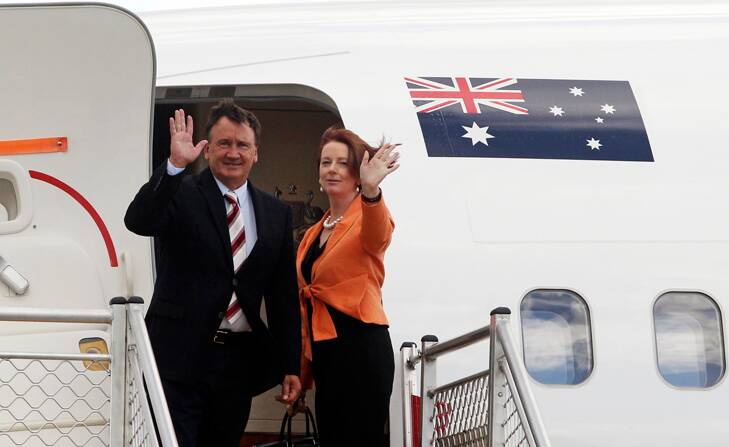 Julia Gillard and partner Tim Mathieson leave Melbourne for Singapore yesterday. Photo: Rebecca Hallas