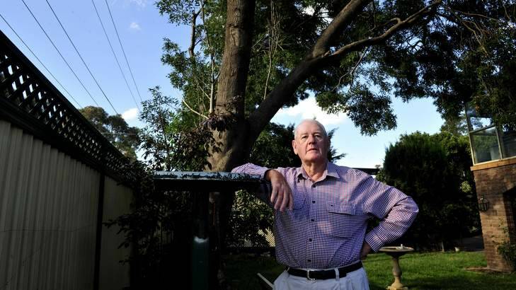 Ian McQuire ,76 of Kaleen has erroneously had his trees cut back from in his backyard by ACTEW. Photo: Melissa Adams