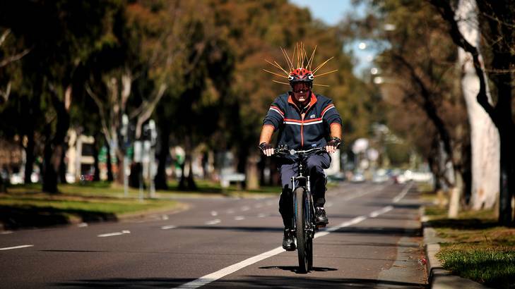 A cyclist along Northbourne Ave today takes the scaring of magpies away to the extreme. Photo: Colleen Petch