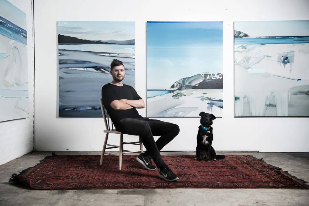 Artist Julian Meagher, here in his studio in Marrickville with dog Lucy, will be exhibiting on the south coast. Photo: Nic Walker