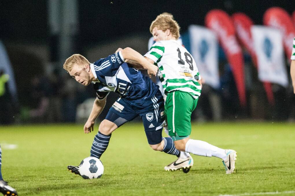 Connor Pain of the Melbourne Victory and Sean Kiddey of Tuggeranong United in last year's FFA Cup match at Viking Park.  Photo: Matt Bedford