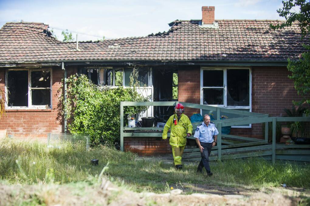 ACT Fire and Rescue clean up at the scene of a house fire on Lynch St in Hughes.  Photo: Rohan Thomson