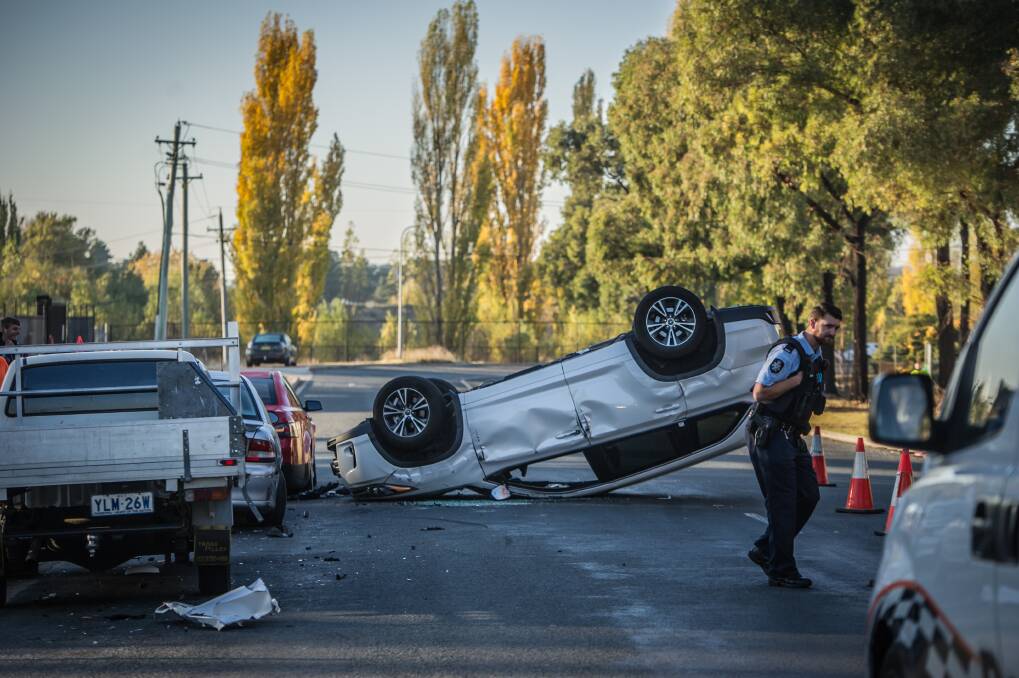 A car rests upside down in Mildura Street, Fyshwick, after crashing into three other vehicles. Photo: Karleen Minney