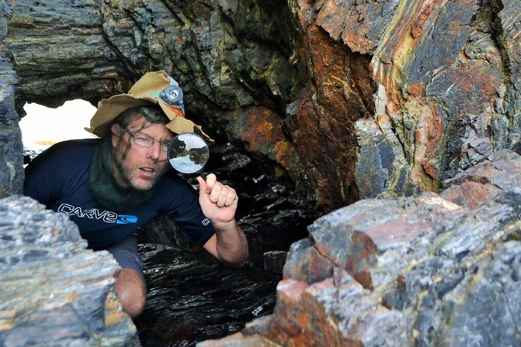 Tim snoops around in a cave on Billys Beach in search of the mystery insects. Photo: Stan Gorton