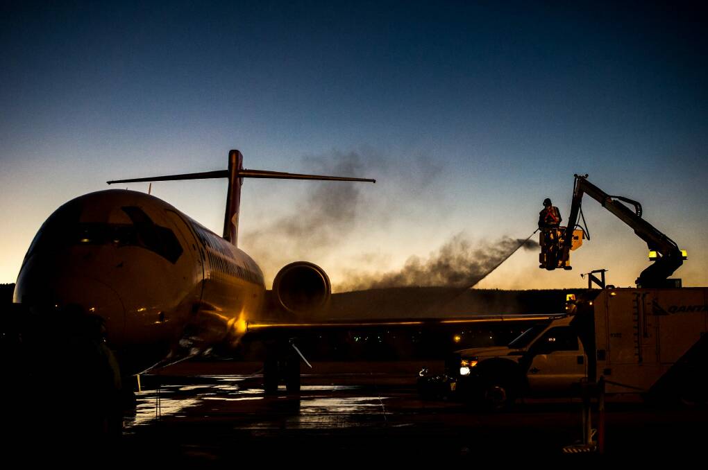 De-iceing work on the Qantas aircraft at Canberra airport in sub-zero temperatures.  Photo: karleen minney