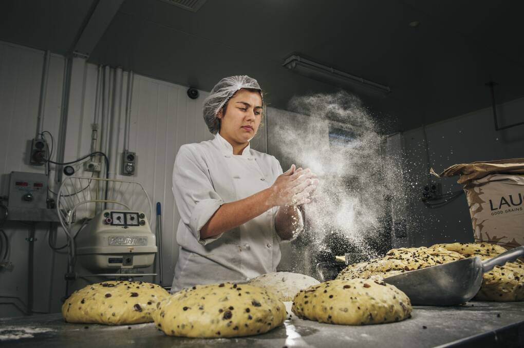 Flute Bakery apprentice pastry chef Elsie Savvoudiou prepares hot cross buns. Photo: Rohan Thomson