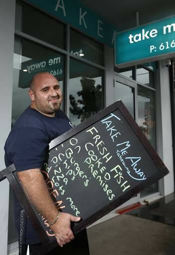 Forde business owner Pat Di Placido from Take Me Away takeaway setting up for another nights trade. Photo: Jeffrey Chan