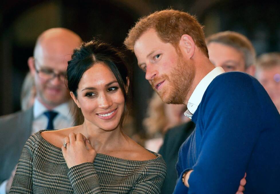 Britain's Prince Harry talks to Meghan Markle as they watch a dance performance by Jukebox Collective in the banqueting hall during a visit to Cardiff Castle, Wales. With Prince Harry and Meghan Markle's May 19 wedding fast approaching, the fashion and bridal worlds are abuzz with talk of who the bride will pick to design her dress and what kind of look she would go for. Photo: Ben Birchall