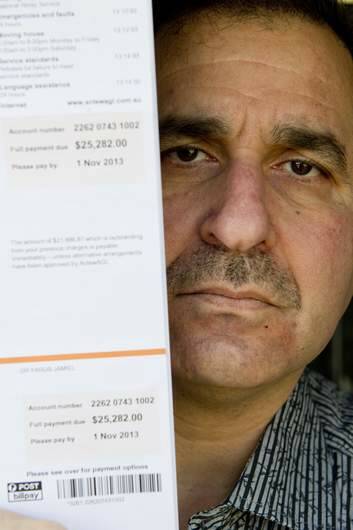 Dr Yarub Jamiel with his latest electricity bill in excess of $25000. Photo: Jay Cronan