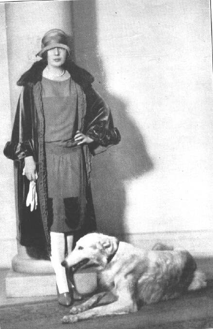 Muriel Starr's ensemble clashes with her dog's fur colour.