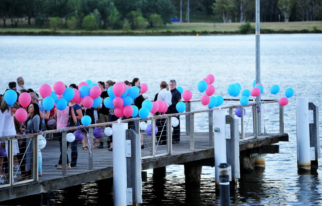 Family and friends gathered at the jetty near the National Museum to release balloons for Cathy Marsh. Photo: Melissa Adams