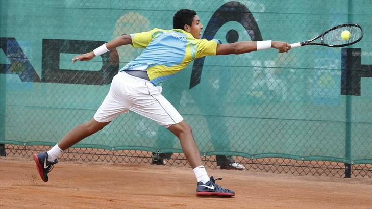 Canberra's Nick Kyrgios slides across the clay during a match at Lyneham in 2012. Photo: Jeffrey Chan