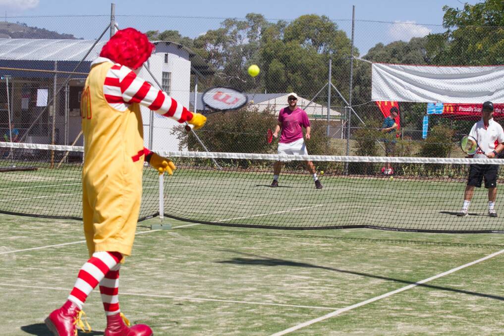 Ronald McDonald, Nick Francis and Robert Jamieson have a hit at last year's 24-challenge at the Pines Tennis Club in Chisholm for Ronald McDonald House Canberra. Photo: Danielle Watson