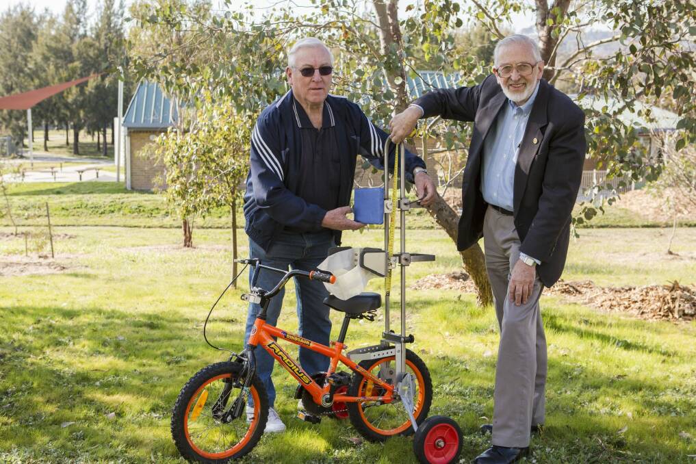 Volunteer Dave Webster and Technical Aid to the Disabled ACT executive director Graham Waite with a Freedom Wheels modular Bicycle for children and young adults who have difficulty with balance, steering or pumping bike pedals.  Photo: Jamila Toderas