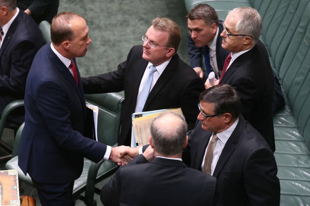 Mr Dutton is congratulated by colleagues after introducing the bill. Photo: Andrew Meares