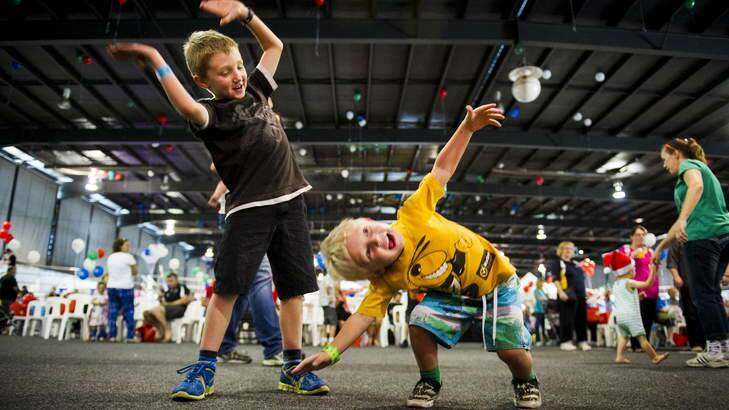 Todd (8) and Nicholas (3) Minogue, from Scullin, dancing during one of the musical performances. Photo: Rohan Thomson