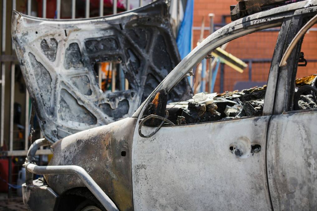 A burnt-out car in Fisher on Wednesday morning after the shooting overnight. Photo: Jamila Toderas
