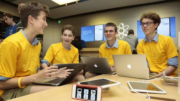 From left, Canberra Grammar School year 8 students Jaxon Kneipp and Damian Camilleri, and year 11 students Josh Whitcombe and Sam Moore during a Code Cadets presentation at the Apple Store; below, staff hand out T-shirts. Photo: Jeffrey Chan