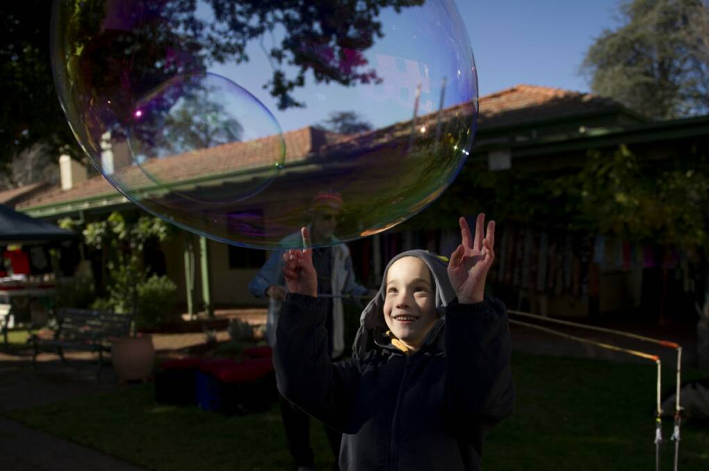 Wyatt Cheeseman, 7, plays with bubbles at the final day of Gorman House markets  on Saturday. Photo: Jay Cronan