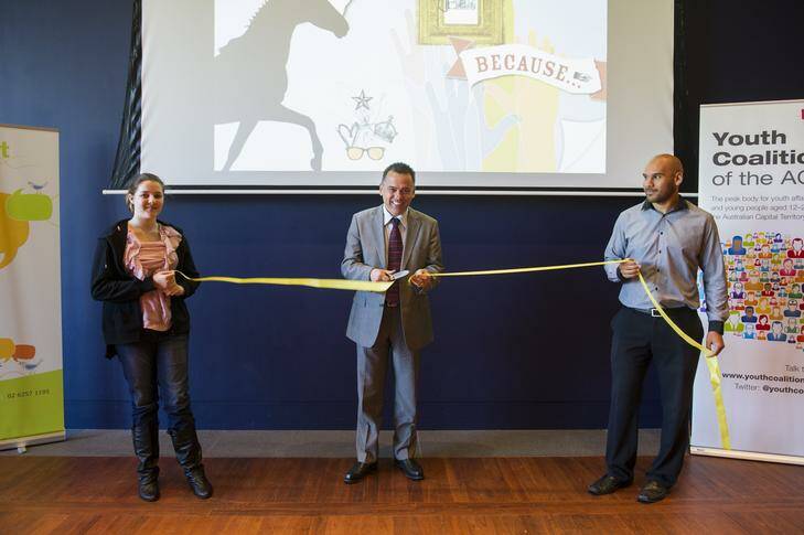 Samantha Garcia, and Bhiamie Williamson, hold the ribbon for MLA Chris Bourke to officially launch Hang on to This (HOTT), a magazine to help youth at risk of mental illness. Photo: Rohan Thomson