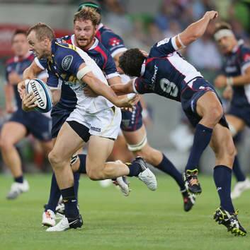 Jesse Mogg of the Brumbies beats the tackle by Nick Phipps. Photo: Scott Barbour