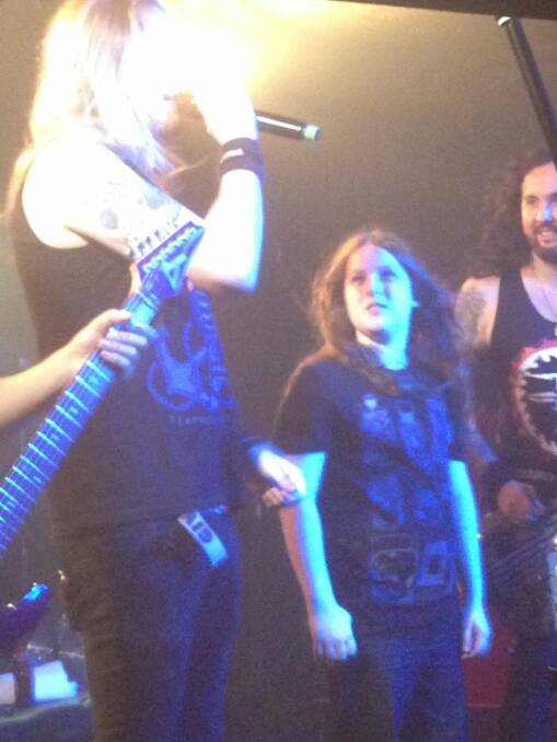 Canberra 12-year-old Callum McPhie on stage with the British heavy metal band DragonForce in Belconnen on Thursday night. Photo: Supplied