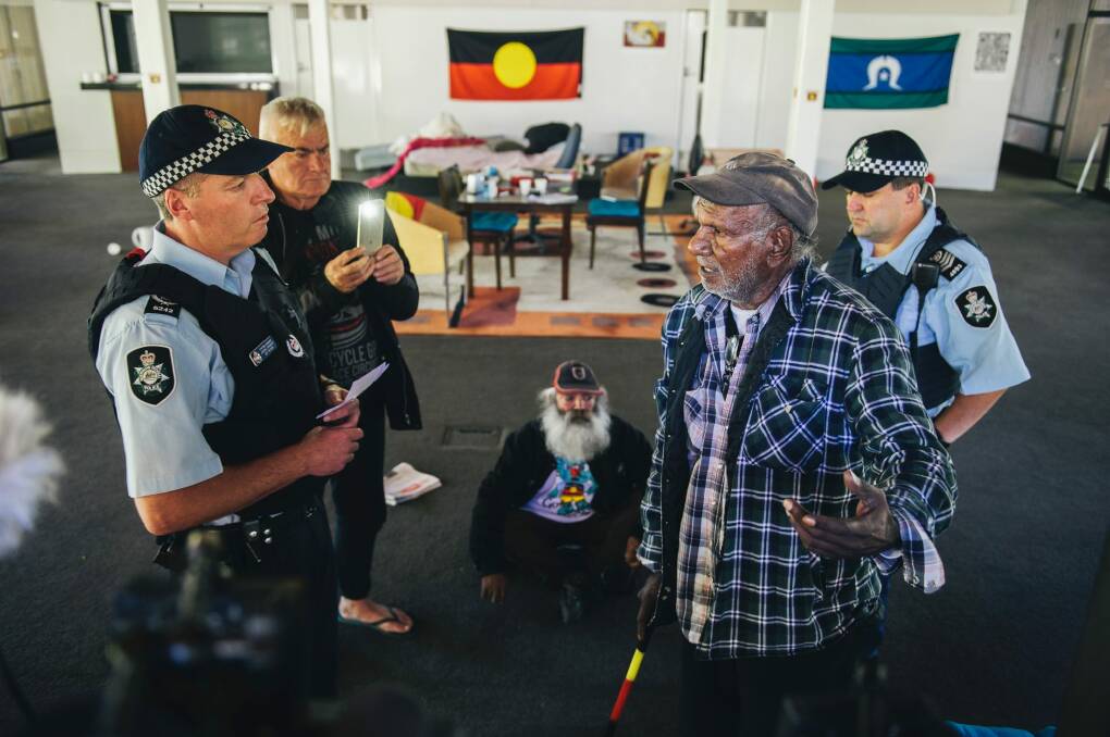Uncle Kevin Buzzacott (right) of the tent embassy speaks to police during the occupation in November. Photo: Rohan Thomson