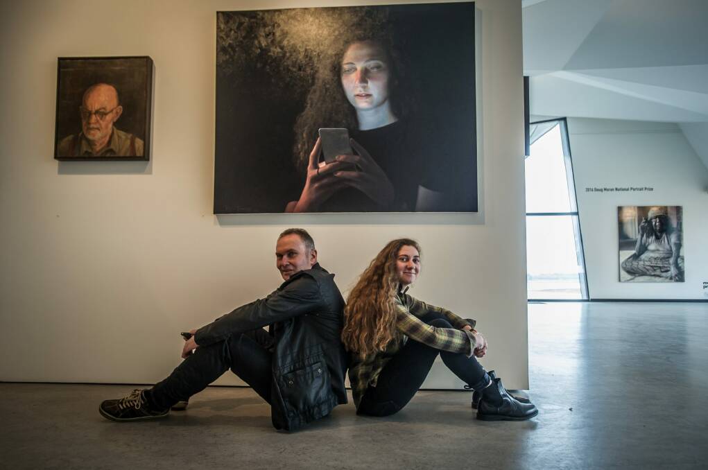 Gordon artist Ross Townsend  with his daughter Hannah, who he painted for the  Doug Moran National Portrait Prize, now showing at the Belconnen Arts Centre. Photo: Karleen Minney