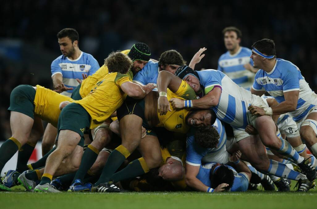 All fall down: Australia collapse a scrum during the match against Argentina at Twickenham. Photo: Alastair Grant