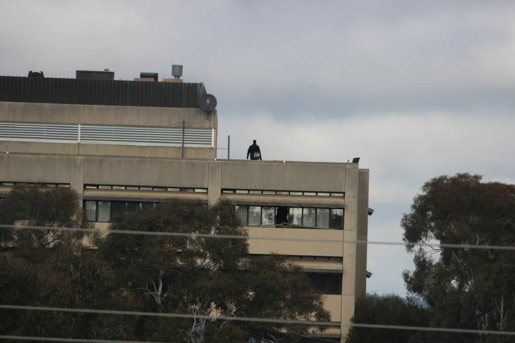 A police officer on the roof of the vacant former CSIRO headquarters in Campbell in May 2017 after reports of trespassing. Photo: Supplied