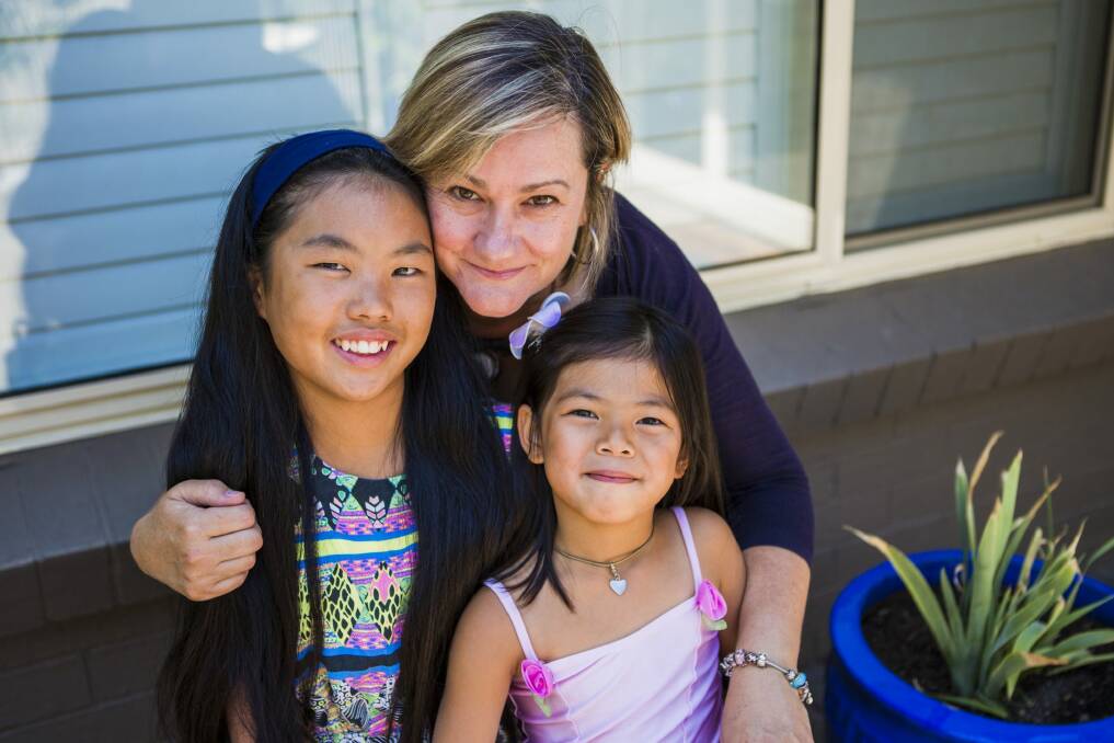 Hughes resident Elizabeth Williams with her two adopted daughters Meiya Williams-Rose, 11 (left), and Anya Williams-Rose, 5.  Photo: Jamila Toderas