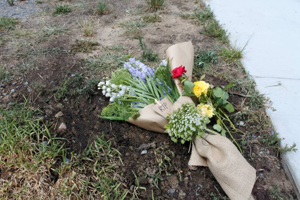 Flowers left at the scene of a motorcycle accident in Queanbeyan where the 22-year-old rider died. Photo: Elliot Williams
