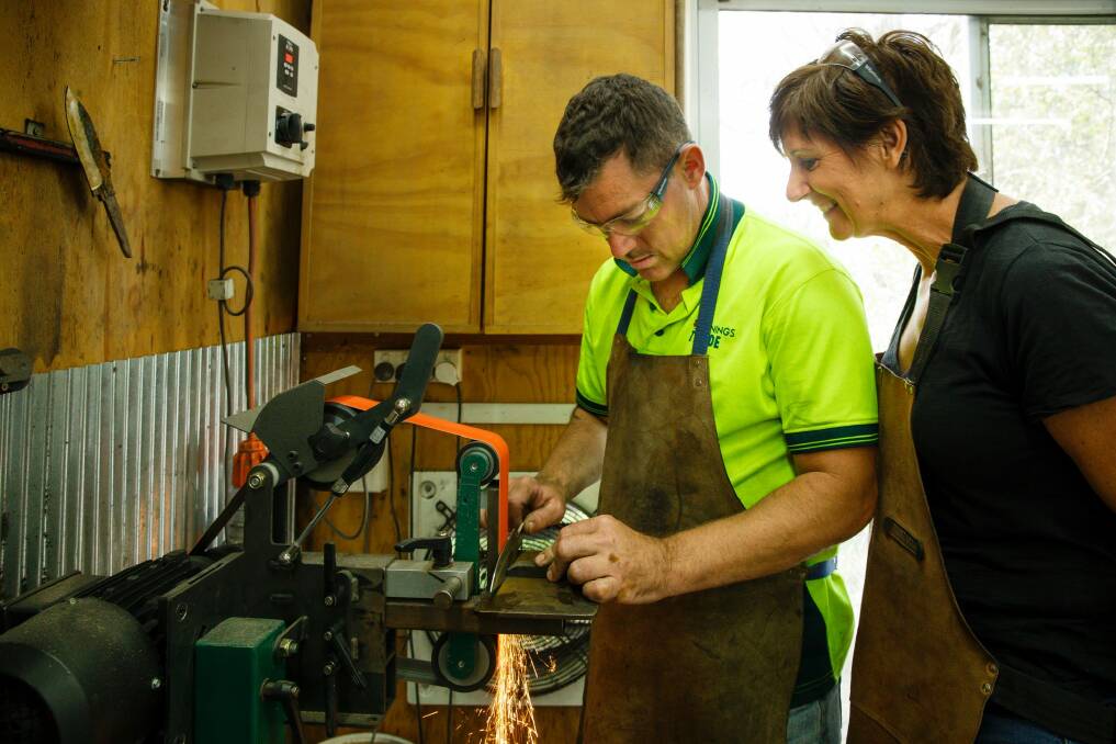 Ken Gilchrist and Christine Svarcas undertaking a knife-making course at Tharwa Valley Forge.  Photo: Sitthixay Ditthavong