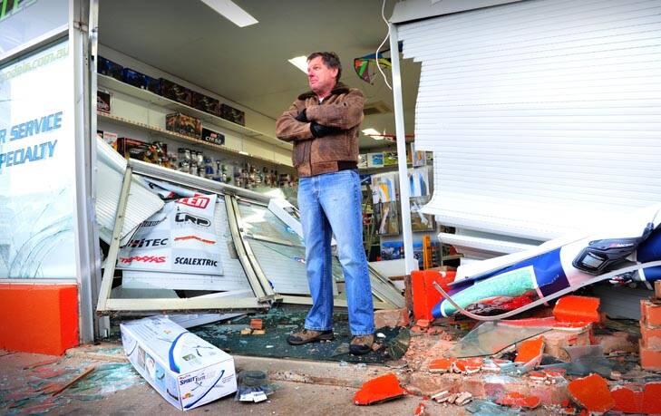 Smash and grab ... shop owner Terry Griffiths looks at the damage done to his Fyshwick business overnight. Photo: Karleen Minney