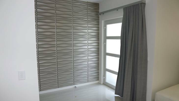 Heavy curtains on the front door prevent heat loss. Photo: Jeffrey Chan