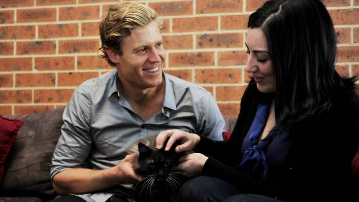 Bondi Vet Dr Chris Brown  makes a house call on Friday to Maria Tsebri who won a competition to get a two-hour consultation for her two cats. Photo: Jay Cronan