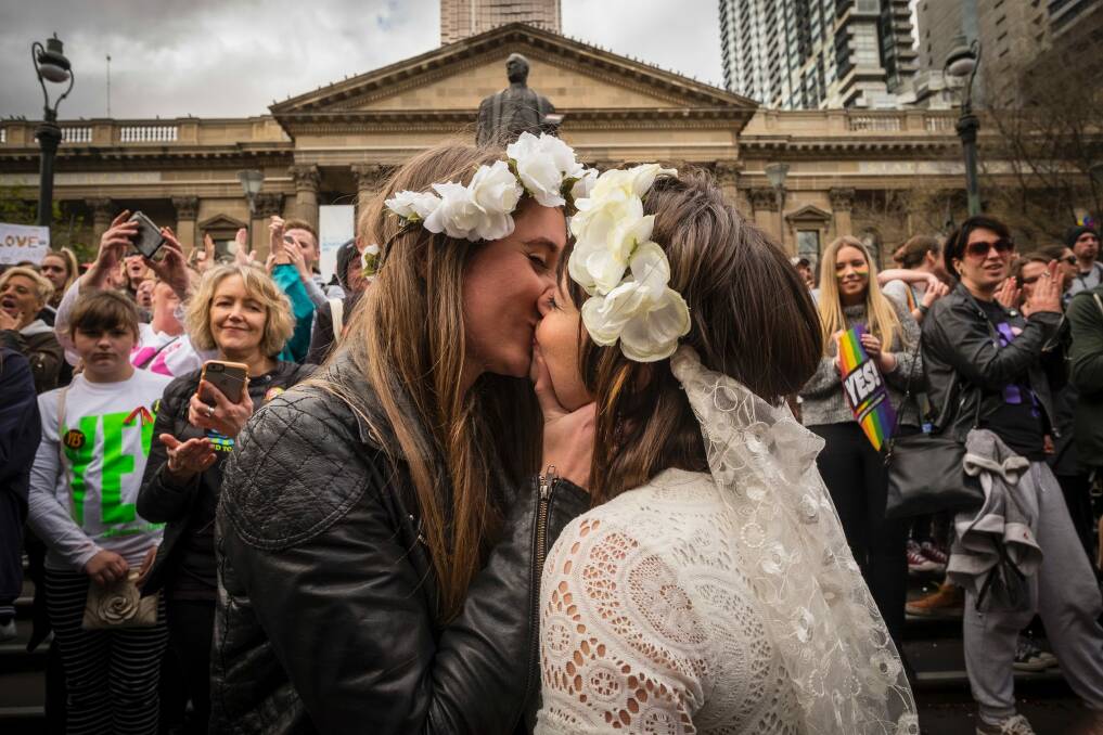 A couple perform a mock wedding ceremony at a rally in Melbourne supporting a yes vote. Photo: Chris Hopkins