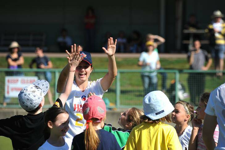 Ellie Brush high-fives kids at a Matildas coaching camp in Canberra yesterday. Brush has been staying fit by playing in Albury's men's competition. Photo: Katherine Griffiths