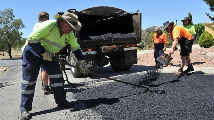 The ACT Government Road Maintainence Team lays bitumen in Carr Crescent, Wanniassa. Photo: Graham Tidy