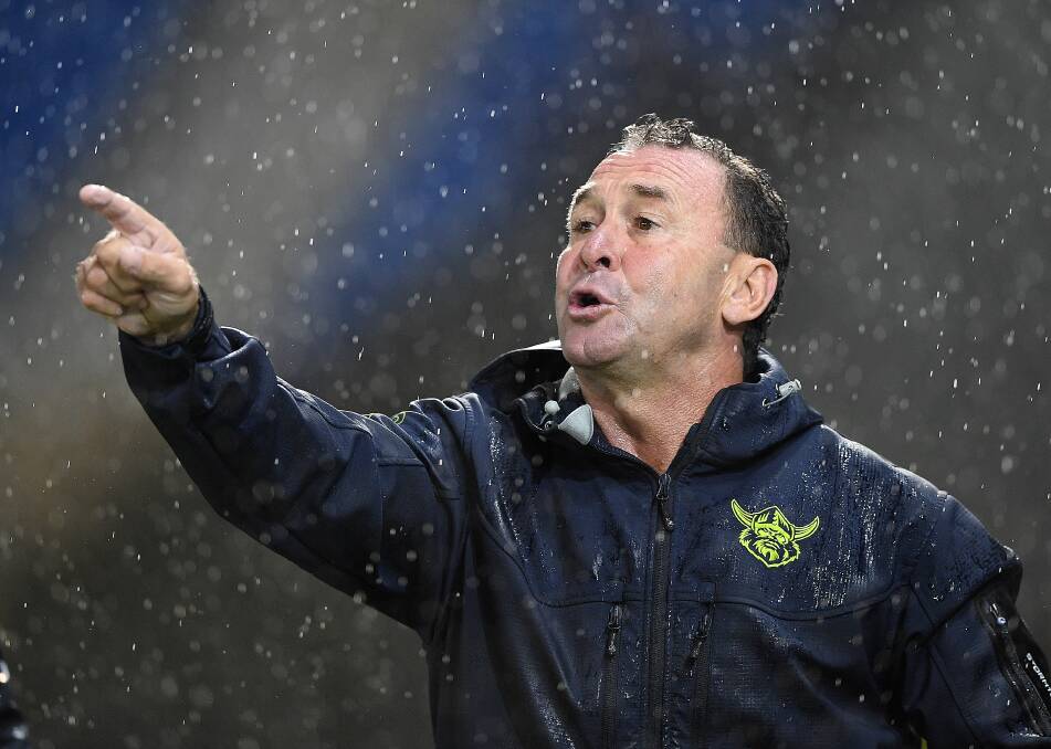No amount of rain will keep Ricky Stuart off the sideline. Photo: Dave Hunt