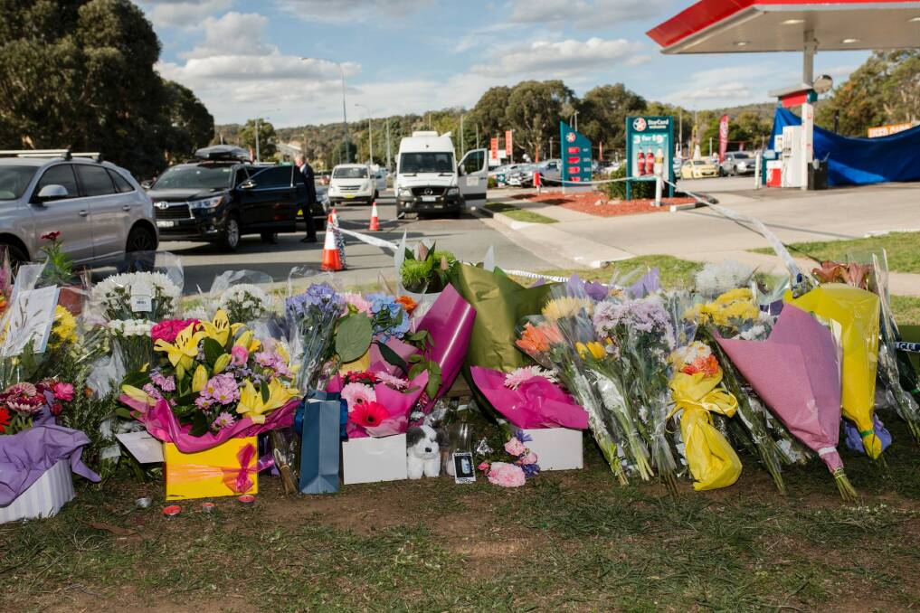 Flowers on Saturday at the scene of the fatal stabbing at the Queanbeyan Caltex service station.  Photo: Jamila Toderas