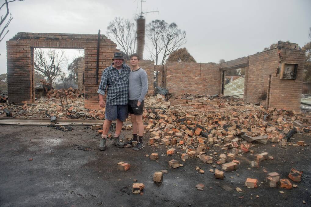 Kevin and Luke Lindley are happy to be alive after their home was destroyed.  Photo: Jay Cronan