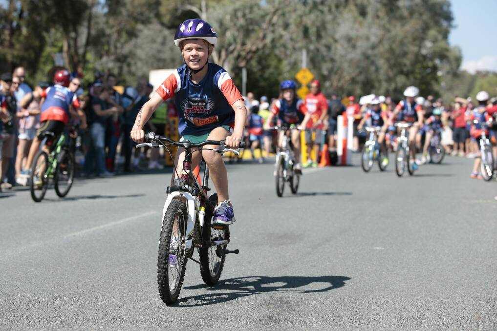 Emma Bennett, of Pambula Beach, rides in the bike leg of the Weet-Bix Kids TRYathlon at the Australian Institute of Sport. Photo: Jeffrey Chan