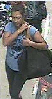ACT Policing is seeking witnesses after two Woolworth stores robbed. The woman was wearing a blue shirt and leggings. On both occasions her red dyed hair was worn in a ponytail. Photo: Spies, Jodie