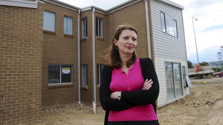 Michelle Philp outside her partially built home in the North Canberra suburb of Bonner. Photo: Graham Tidy