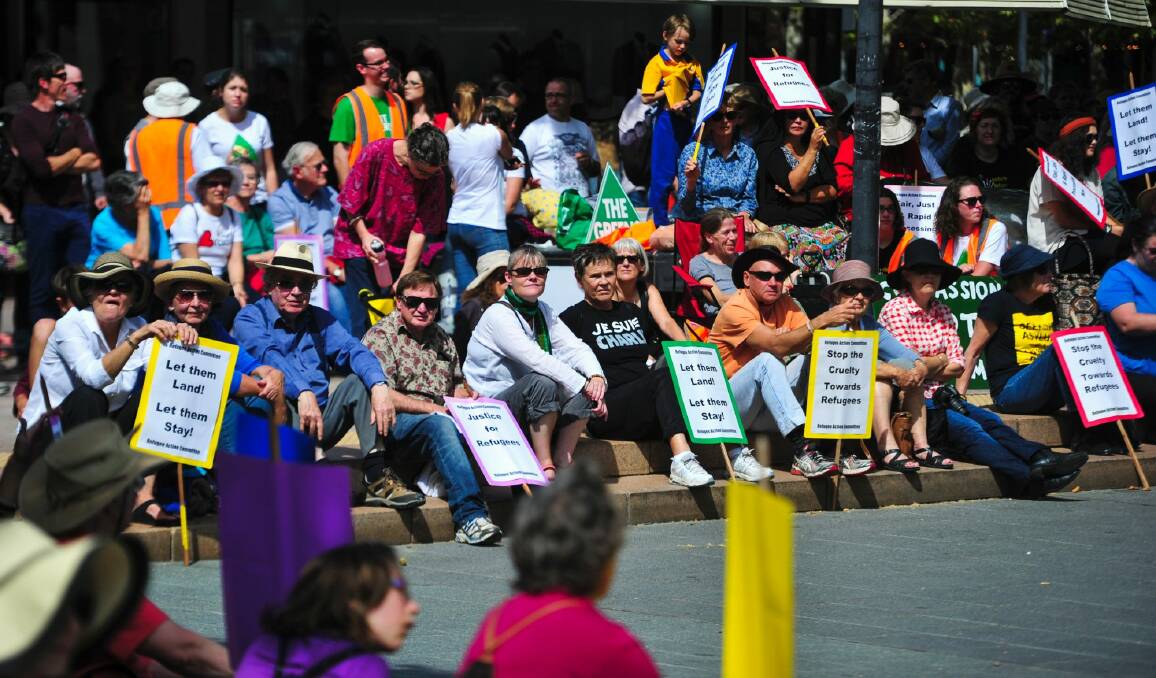 People gather in Garema Place in Civic for the Palm Sunday refugee rally. Photo: Melissa Adams