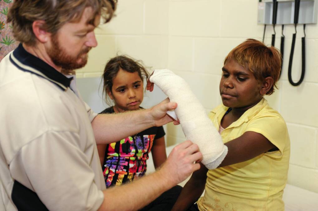RAHC registered nurse Aaron Richardson on placement in Ampilatwatja in the NT. Photo: Steve Strike